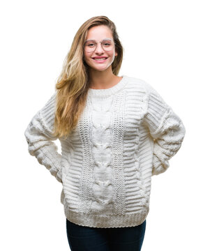 Young beautiful blonde woman wearing winter sweater and sunglasses over isolated background with a happy and cool smile on face. Lucky person.