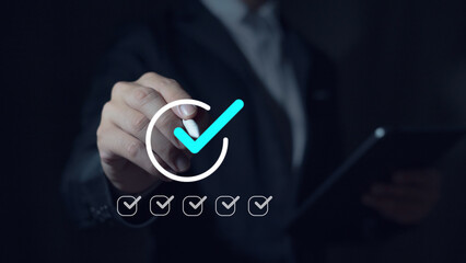 Complete the digital form checklist Businessman uses laptop to complete online checklist survey on...