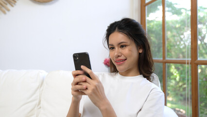 Young woman using smartphone browsing for online shopping E commerce by online payment gateway at...