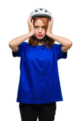 Young beautiful woman wearing cyclist helmet over isolated background suffering from headache desperate and stressed because pain and migraine. Hands on head.