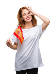 Young beautiful woman holding flag of spain over isolated background with happy face smiling doing ok sign with hand on eye looking through fingers