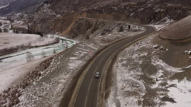 Driving Chuiskiy trakt road in winter. Famous Chuiskiy trakt highway in Altai. Aerial footage