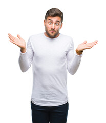 Fototapeta premium Young handsome man over isolated background clueless and confused expression with arms and hands raised. Doubt concept.
