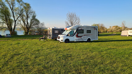 Campers parked on a Camer Van pitch. Concept camper van leisure and fun