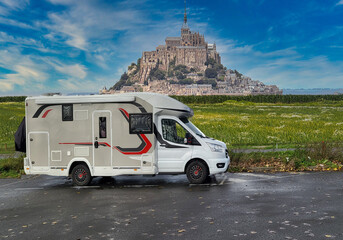 Motorhome with awning in France in front of Le Mont-Saint-Michel