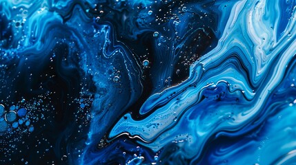 A close up of blue and black paint. - obrazy, fototapety, plakaty