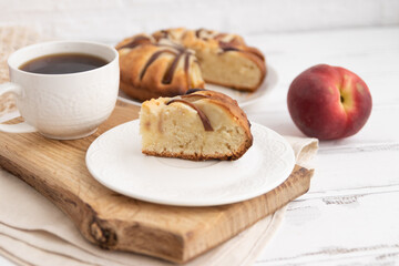 peach pie on a wooden table on a board and tea.The concept of breakfast.