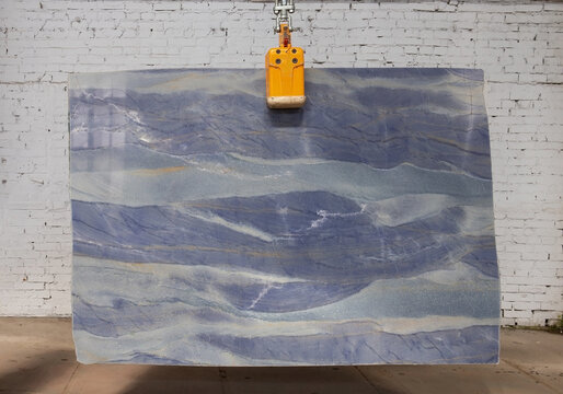 Picture of a marble slab on a hanger, shot in natural light, a cut of decorative marble in a warehouse, a large piece of marble. High Resolution. Quarzite Azul Boquira
