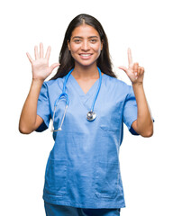 Young arab doctor surgeon woman over isolated background showing and pointing up with fingers...