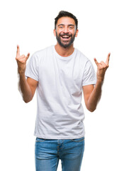 Adult hispanic man over isolated background shouting with crazy expression doing rock symbol with hands up. Music star. Heavy concept.