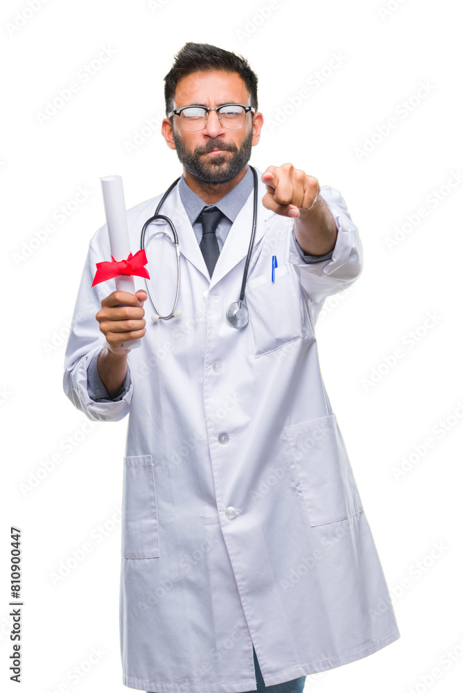 Wall mural Adult hispanic doctor man holding degree over isolated background pointing with finger to the camera and to you, hand sign, positive and confident gesture from the front