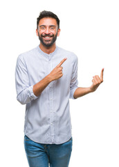 Adult hispanic man over isolated background smiling and looking at the camera pointing with two hands and fingers to the side.