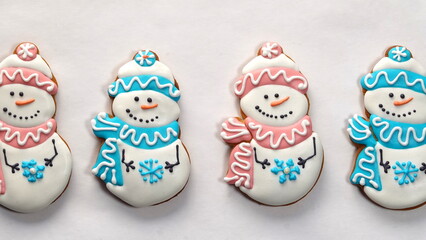 Gingerbread snowmen on a white background. Blue And Pink hats. Four Figures Isolated