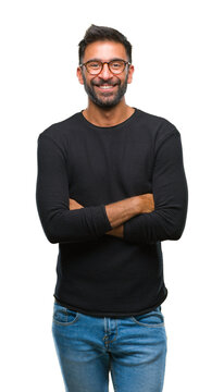 Adult hispanic man wearing glasses over isolated background happy face smiling with crossed arms looking at the camera. Positive person.
