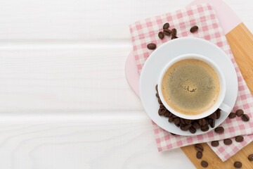 Cup of coffee on wooden background, top view