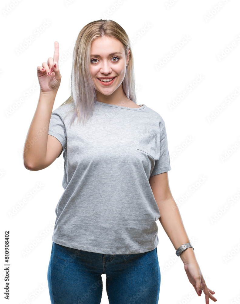 Sticker Young blonde woman over isolated background pointing finger up with successful idea. Exited and happy. Number one.