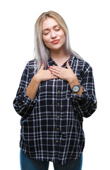 Fototapeta premium Young blonde woman over isolated background smiling with hands on chest with closed eyes and grateful gesture on face. Health concept.