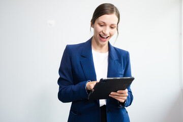 Confident Caucasian businesswoman CEO idea holding tablet and laptop for remote work, online...