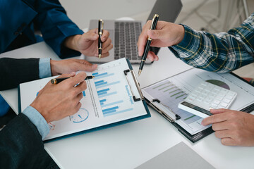 A team of young entrepreneurs and Asian startups held a business meeting. to achieve the marketing plan Businessmen talking in a conference room. Business. Population. Company.