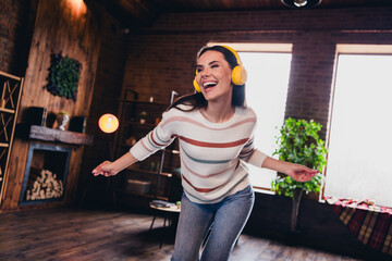 Photo of lovely young woman dancing listen music headphones wear striped outfit interior home...