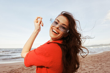 Smiling Woman: Portrait of a Carefree, Trendy Model in Colourful Sunglasses, Enjoying the Freedom of a Beach Vacation at Sunset