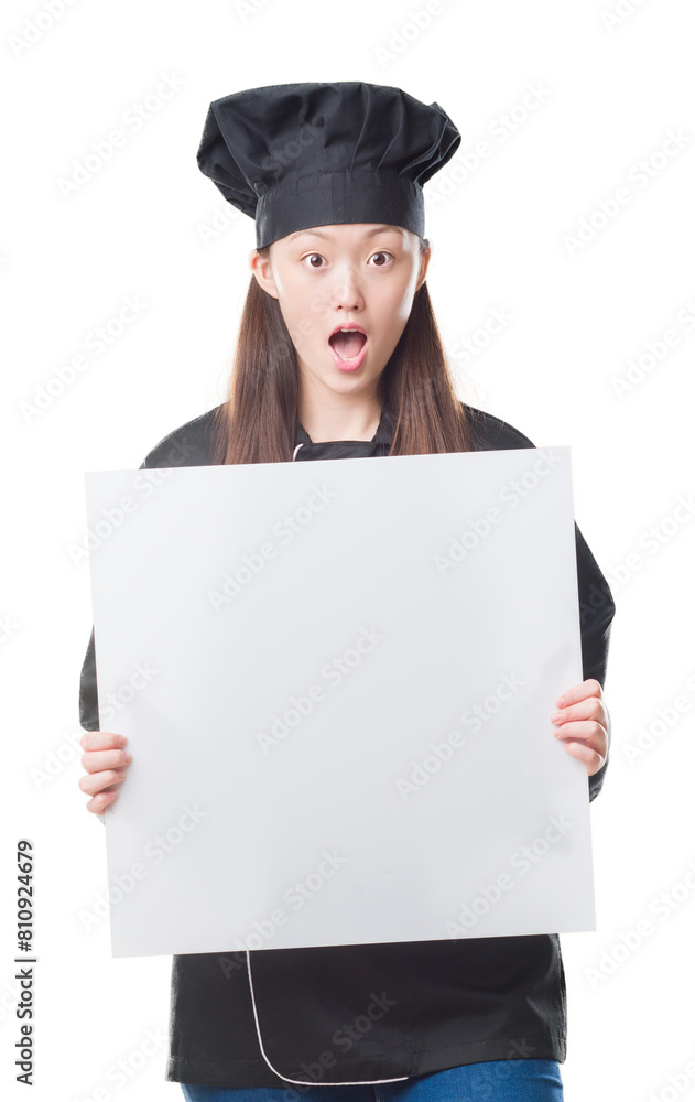 Wall mural Young Chinese woman over isolated background wearing chef uniform holding banner scared in shock with a surprise face, afraid and excited with fear expression