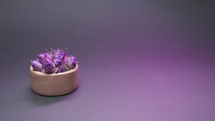 Dried damask rose in small wooden bowl