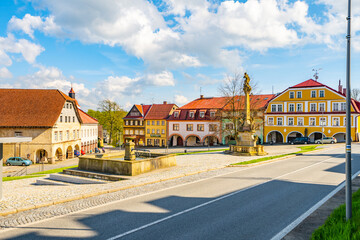 A picturesque view of a peaceful square in Zacler, Czech Republic. Colorful buildings with classic...