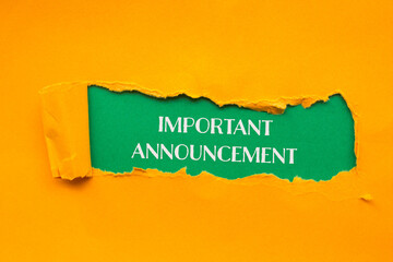 Important announcement words written on torn orange paper with green background. Conceptual...