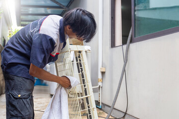 Repairman washing dirty cover air conditioners, Technician man clean air conditioning system, Maintenance and service concepts