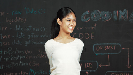 Young student celebrate her successful plan while raise her arm. Happy teenager looking at camera...