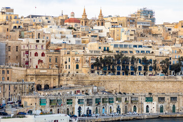 Old yellow buildings of Valletta, the capital of Malta, seen from the Mediterranean sea.