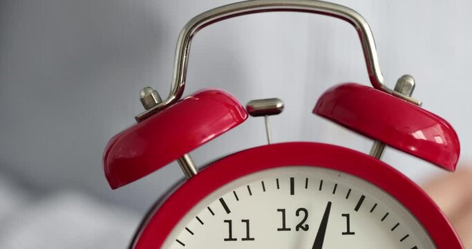 Red alarm clock ringing in morning closeup 4k movie slow motion. Punctuality compliance with regime concept