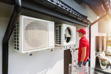 Caucasian Professional HVAC Technician Performing Air Condition and Heat Pump Units Maintenance