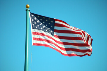American flag waving on an azure background, symbolizing Memorial Day patriotism.