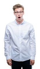 Fototapeta premium Young handsome blond man afraid and shocked with surprise expression, fear and excited face.