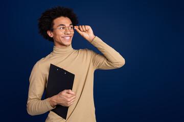 Photo portrait of attractive young man look empty space hold documents dressed stylish beige...