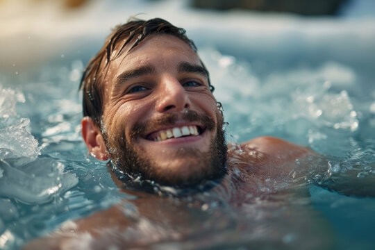 A man using an ice plunge pool bath for recovery after sports exercise