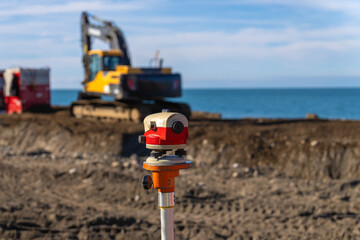 Close-up image of optical level or surveying instrument used to measure angles and distances on...
