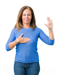 Middle age beautiful woman wearing winter sweater over isolated background Swearing with hand on...