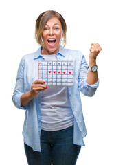 Obraz premium Middle age senior hispanic woman holding menstruation calendar over isolated background screaming proud and celebrating victory and success very excited, cheering emotion