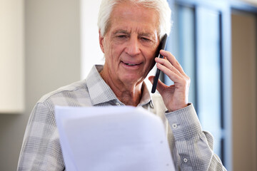 Elderly, man and phone, paperwork or retirement, finance budget and mortgage, bills and taxes, reading and account for home loan. Senior, person and talk, document or notice of insurance fees