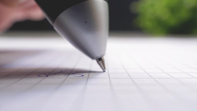 Ballpoint pen. Person's hand writes numbers on a piece of paper. Macro shot