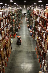 Forklift navigating through aisles in a well-stocked warehouse
