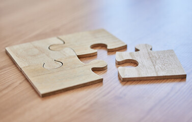 Abstract, strategy, puzzle on desk in office closeup for creative career, game or solution. Development, planning and vision with jigsaw pieces on wooden table in workplace for business challenge