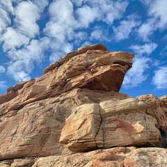 Marvel at the grandeur of nature with this stunning image showcasing a large rock formation set against the expansive sky