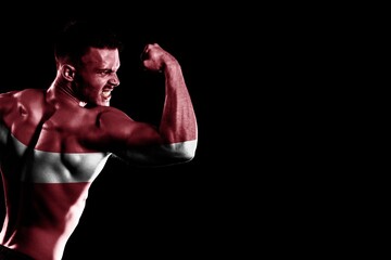 Latvia flag handsome young muscular man black background