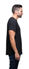 Young handsome man over isolated background looking to side, relax profile pose with natural face with confident smile.