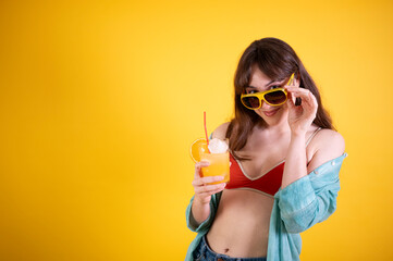 Young Woman Enjoying a Refreshing Orange Drink in Summer