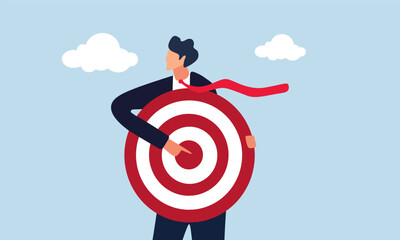 Businessman holding archer target or dashboard pointing at bullseye, focus on business target, and setting goal for motivation